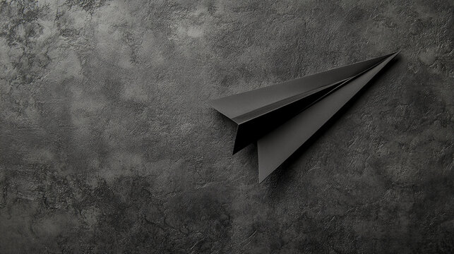 Black Paper Airplane on a Textured Dark Surface, Concept of Minimalism, Elegance, and Creativity, Ideal for Backgrounds, Mockups, or Business Concepts