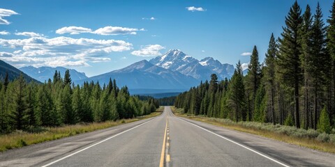 Fototapeta premium Empty stretch of asphalt road running parallel to a mountain range with a clear blue sky above and pine trees in the foreground, road to nowhere, asphalt road, mountain view