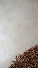 A pile of coffee beans in the bottom right corner with a blank space above for text against a gray background