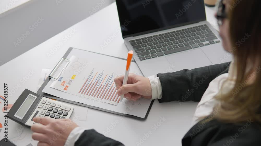 Aufkleber a skilled professional analyzes financial data with a calculator and laptop, reviewing reports and s