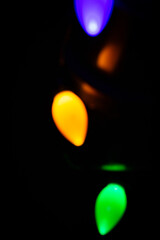 Blurred Christmas lights against black background