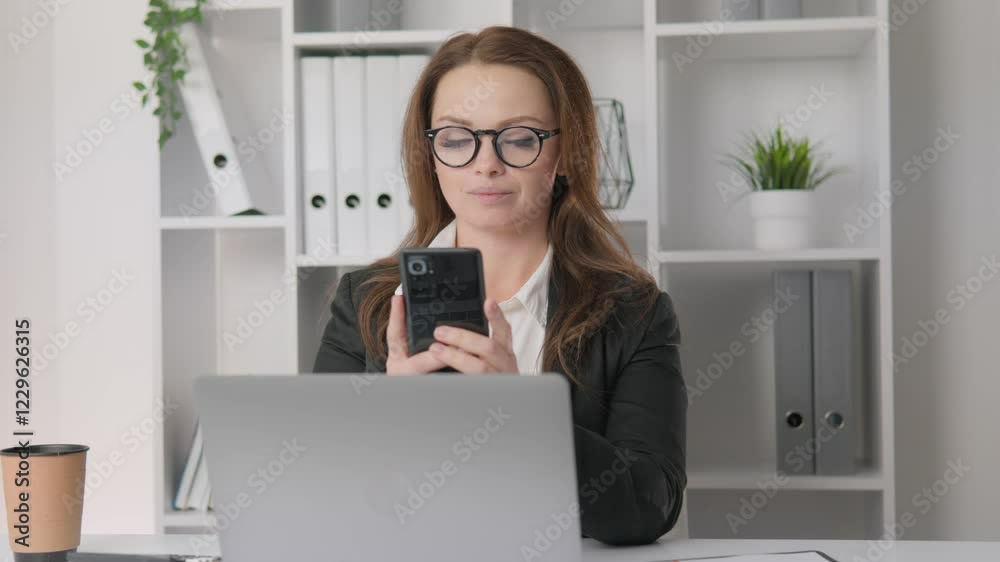 Poster a dedicated professional woman is deeply engaged in her work while seated at her desk, skillfully us