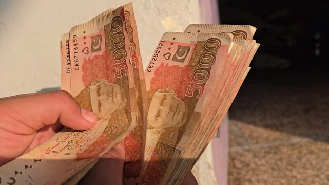 Counting Pakistani Currency Bank Notes