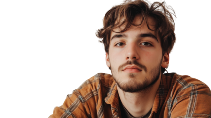 Young man with brown hair and beard posing against a light background in casual attire, displaying a relaxed expression
