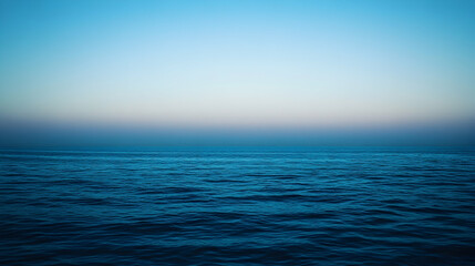 Fototapeta premium Serene ocean at twilight, tranquil blue water meeting a calm sky. Perfect for meditation, relaxation, or travel themes.