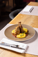 Tender duck legs glazed in a tangy orange sauce, plated elegantly for a gourmet touch