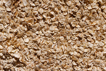 close up raw oatmeal flakes background