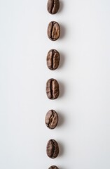A vertical line of coffee beans on the right side on a white background