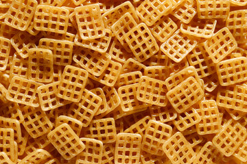 close up raw brushwood chips on yellow background 