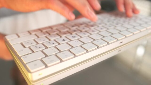 Extreme close up of hands typing on a keyboard, showcasing the process of drafting and editing text, creating presentations, and preparing business reports for professional purposes.