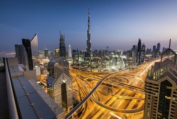 View of skyline from Shangri La Hotel at dusk, illuminated Sheikh Zayed Road, Burj Khalifa,...