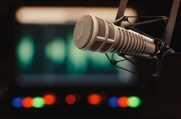 Professional microphone and sound wave form on screen