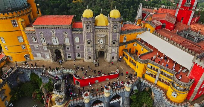 Tourists Exploring Famous Pena Palace Castle In Sintra Portugal Aerial Vibrant Tilt Up