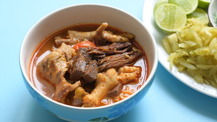 rice vermicelli with northern thai curry sauce on blue background