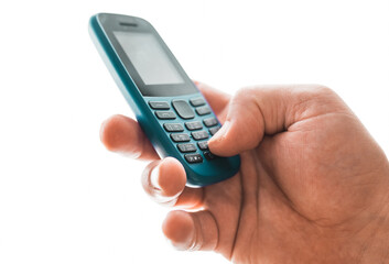 Man hold a dumbphone. An old phone. Digital minimalism concept.