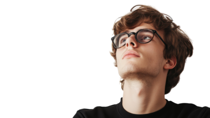 Young man with glasses gazes upward in thoughtful contemplation against a plain background