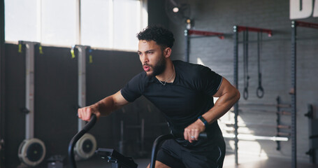 Fitness, man and bicycle machine in gym for exercise, cardio workout and training. Athlete,...