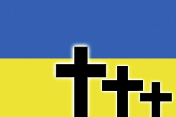 The Ukrainian flag and the silhouettes of tombstones crosses