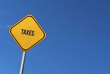 Taxes, yellow sign with blue sky