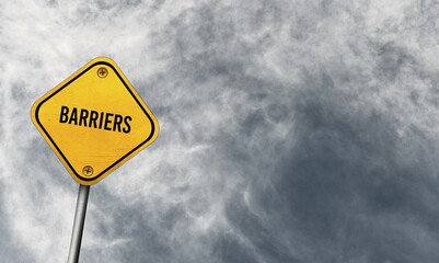Barriers, yellow sign with cloudy sky