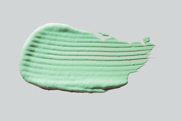 Cosmetic texture background green clay mask, peeling gel or cleansing foam isolated on grey