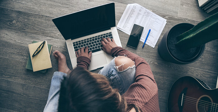 Young woman working on laptop at home. Female hands typing on pc keyboard. Teennager making an Internet video call with remote friends. Girl studying online. Technology, youth, teen, new life  concept