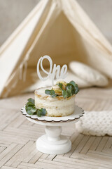 Birthday cake with word one on the topper