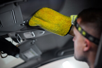  Person dry cleaning a car with glove 