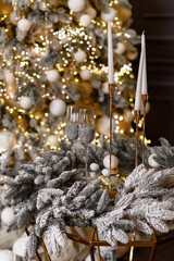 Two glasses standing on the table before the Christmas tree
