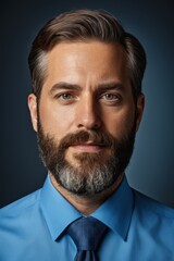 arafed man with a beard and a blue shirt and tie