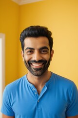 Fototapeta premium smiling man with a beard and mustache in a blue shirt