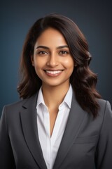 smiling woman in a business suit with a white shirt and black jacket