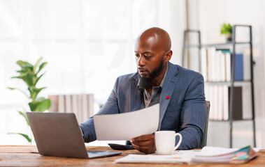 African American business man Accounting using calculating income-expenditure and analyzing real...