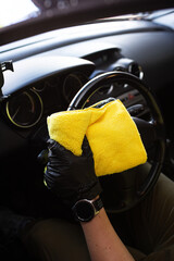 Dry cleaning the car with microfiber mop