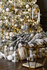 Two glasses standing on the table before the Christmas tree