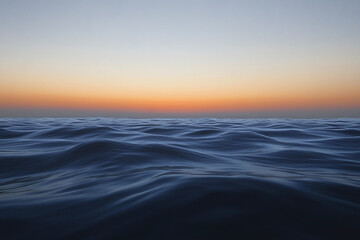 Sunset over calm ocean waters creates a serene atmosphere with vibrant colors on the horizon