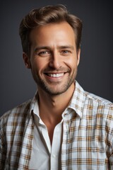 Obraz premium smiling man in plaid shirt with short hair and beard