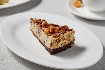 Decadent Peanut Caramel Cheesecake on a White Plate