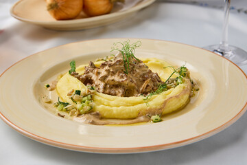 Elegant Presentation of Mashed Potatoes with Veal Stroganoff in Warm Tones