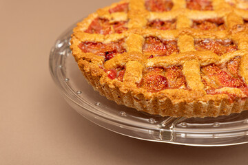 Italian style fig tart with a crisp lattice design and juicy filling, baked to perfection and served on a clear glass platter for elegant presentation