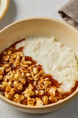 Rustic Rice Porridge with Caramel Peanuts Cozy Warm Tones and Soft Lighting