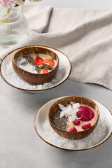 Vibrant Smoothie Bowls with Berries and Chia Seeds on Ice in Rustic Coconut Shells
