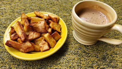 fried cassava breakfast with onion seasoning and a cup of hot cappuccino