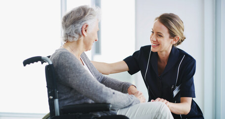 Clinic, caregiver and kindness for woman with disability, smile and listening for emotional...