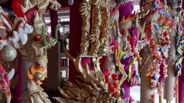 Close up of large joss sticks with intricate dragon patterns for sale