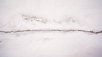 Cracked Old Wall with Central Crevice and Water Stains on White Painted Surface