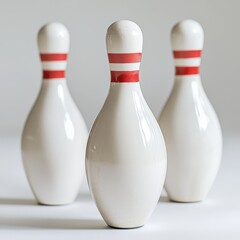 White bowling pins with red stripes on a white background