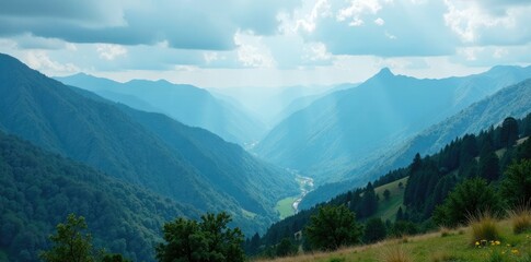 Obraz premium misty mountains rise up from the valley below under an overcast blue sky, mountains, landscape