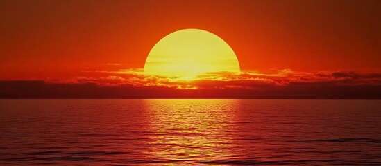 Fiery Sunset Over Calm Ocean: A breathtaking view of the sun dipping below the horizon, casting a vibrant orange glow across the tranquil waters.