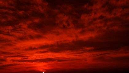 Obraz premium Abstract dark red background. Dramatic red sky. Red sunset with clouds. Fantastic sunset background with copy space for design. Halloween, armageddon, apocalypse, end of the world concept
